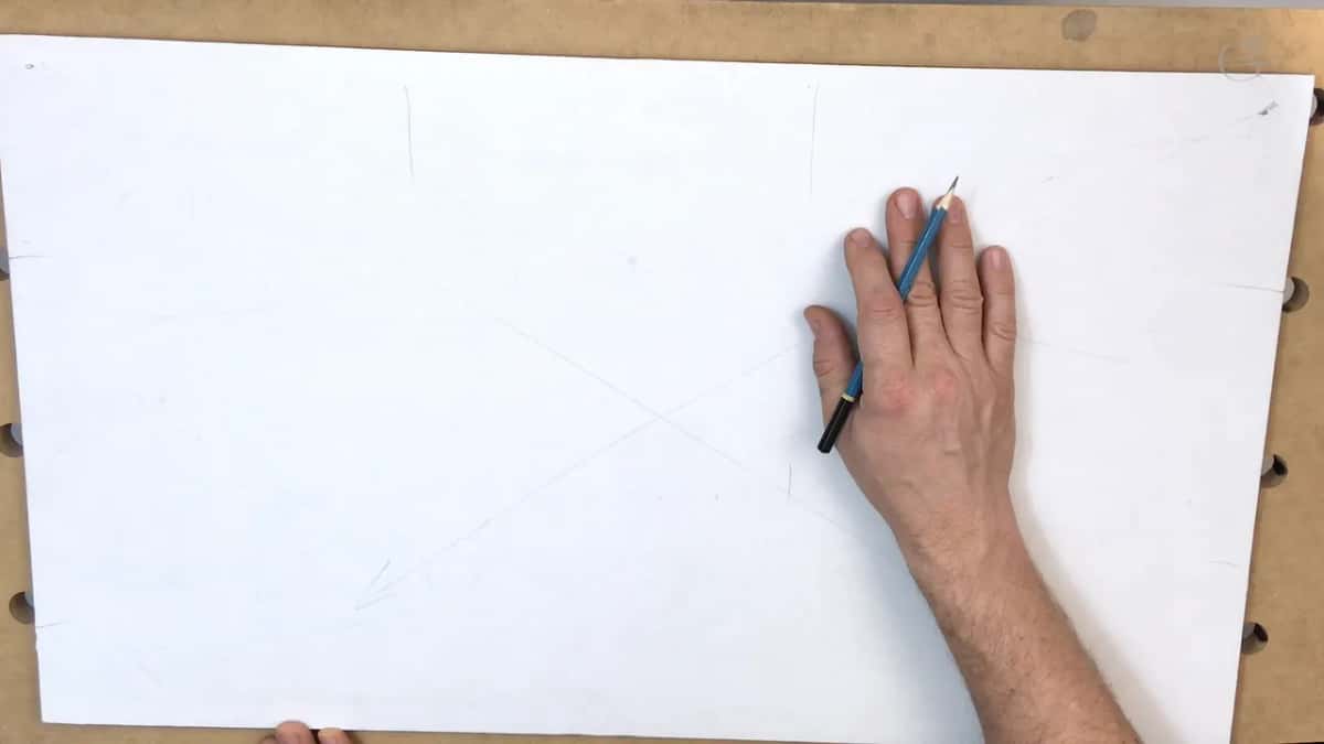 A blue pencil in the right hand, which rests flat on the paper beside faint diagonal lines and an arrow