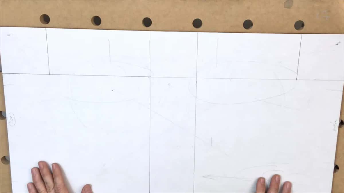 Fingertips along the bottom of the ruled grid, the word Top circled at the left end