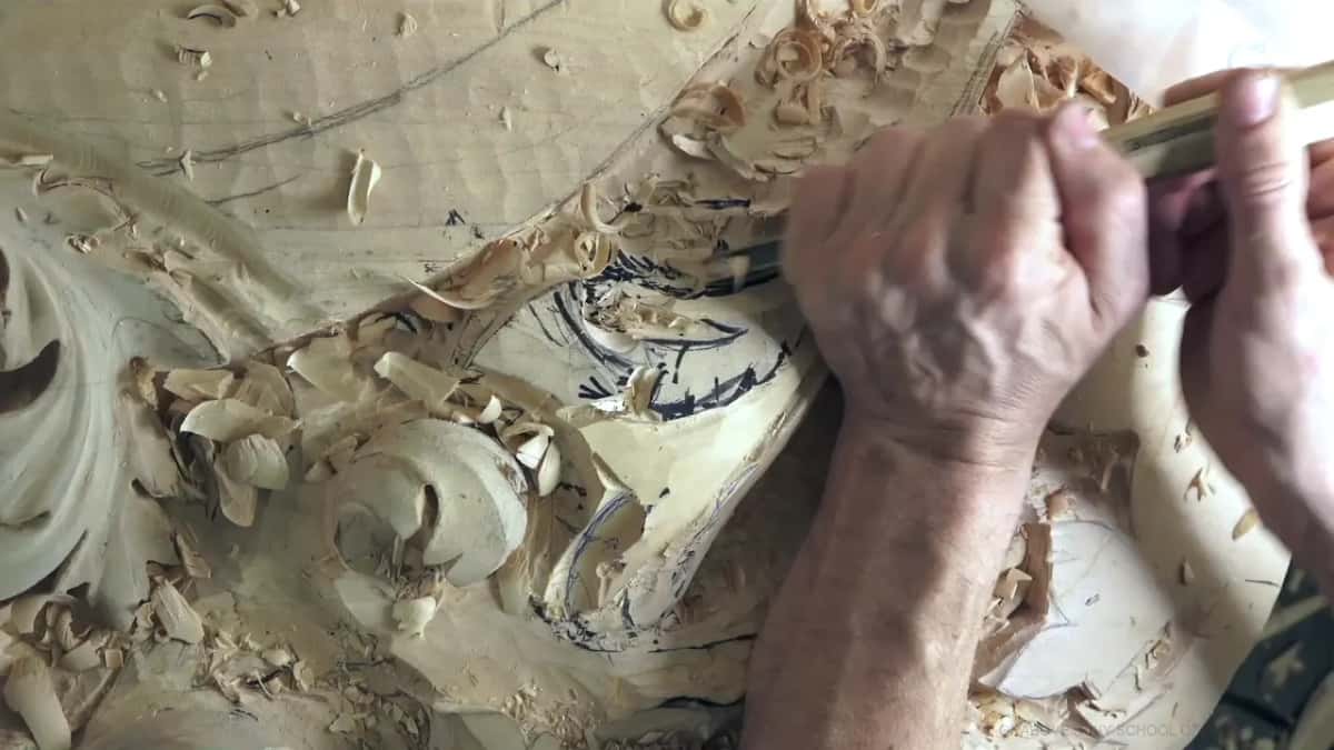 Knuckles over a gouge that follows a black marker line through the chips.