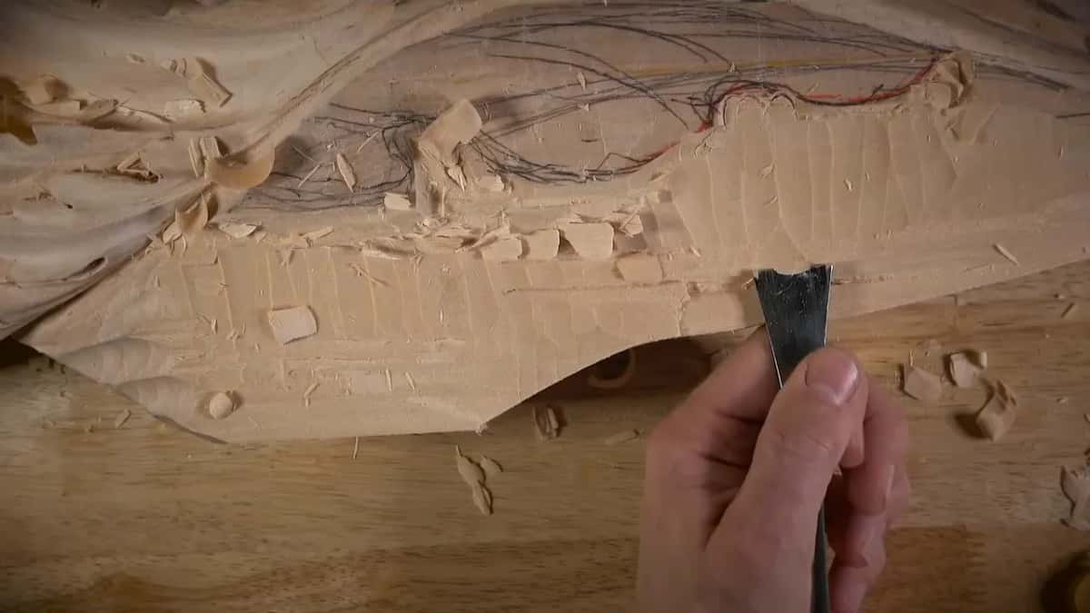 Upright gouge at the chopped edge, with a red line higher on the wood