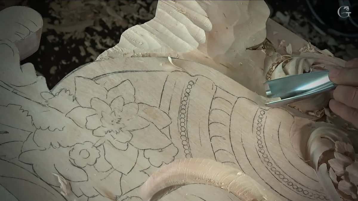 Deep curved blade low against the pencil outline, flowers sketched beneath