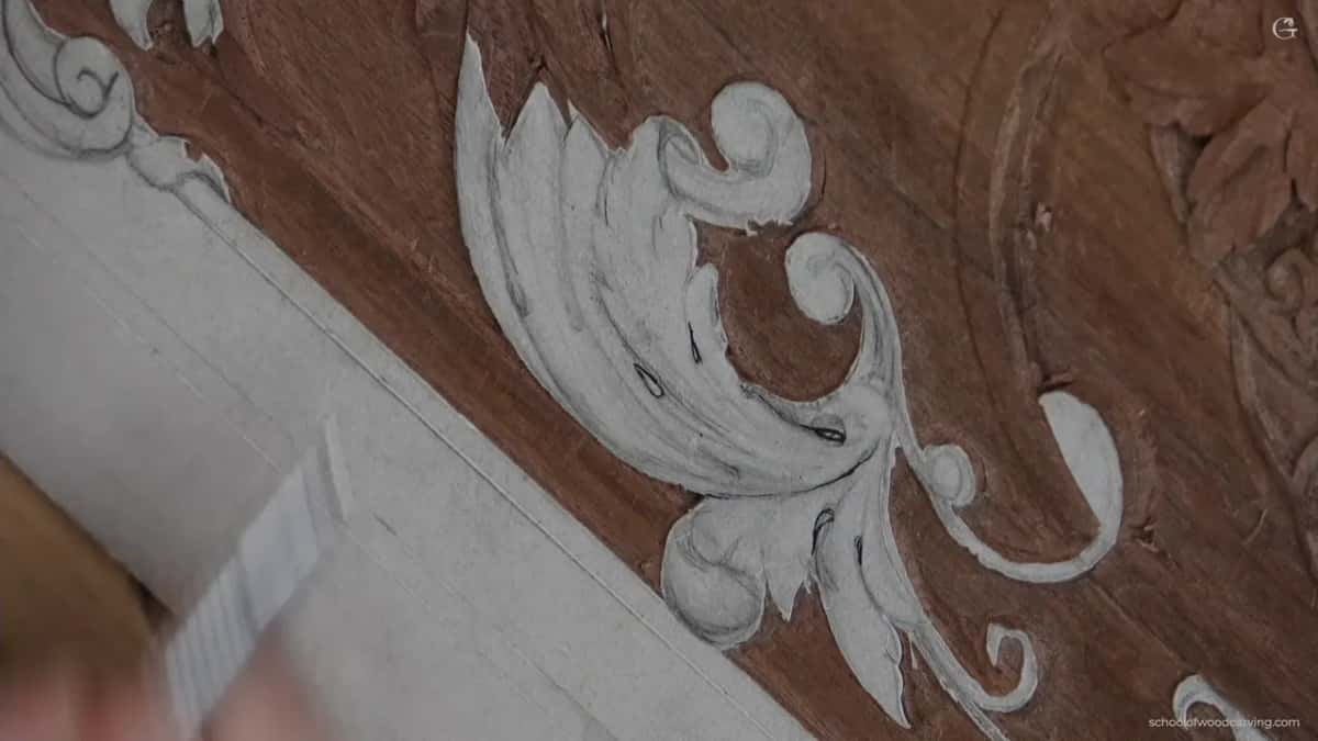 Small dark eye marks inked onto the white paper leaf, with a blurred marker barrel in the corner