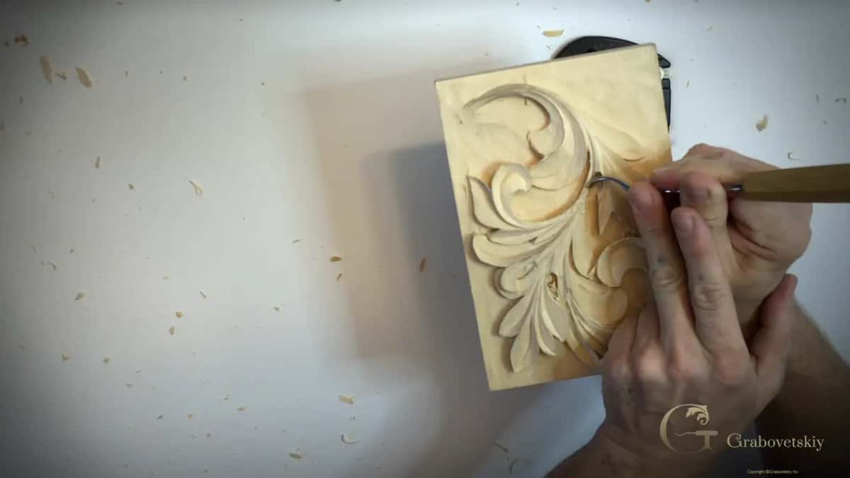 Long pale handle coming in from the right, both hands on it