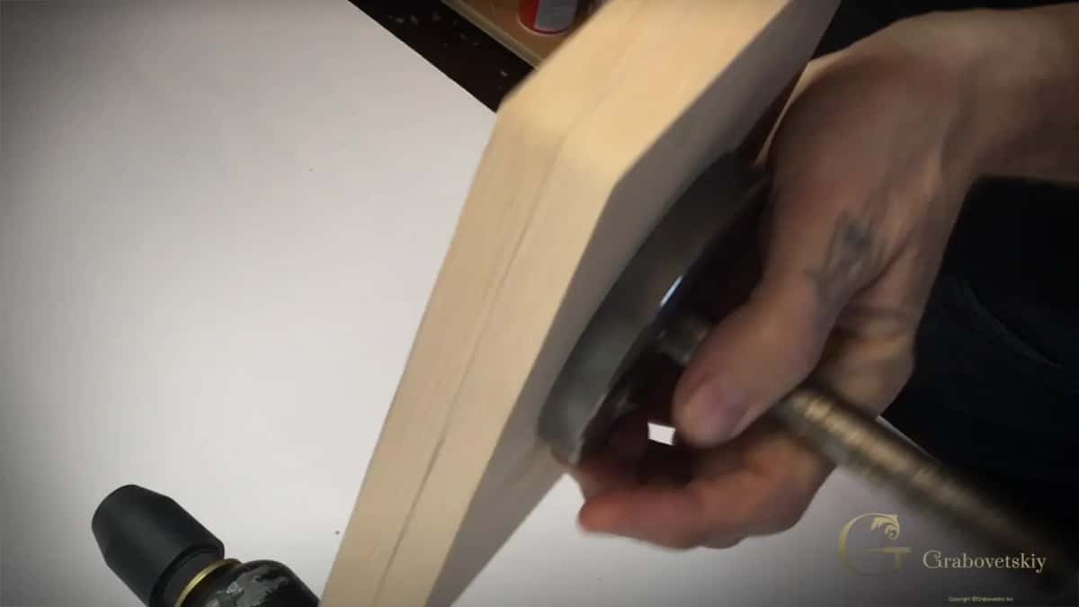 Block on its round mounting plate and rod, with one pencil line already running along the edge