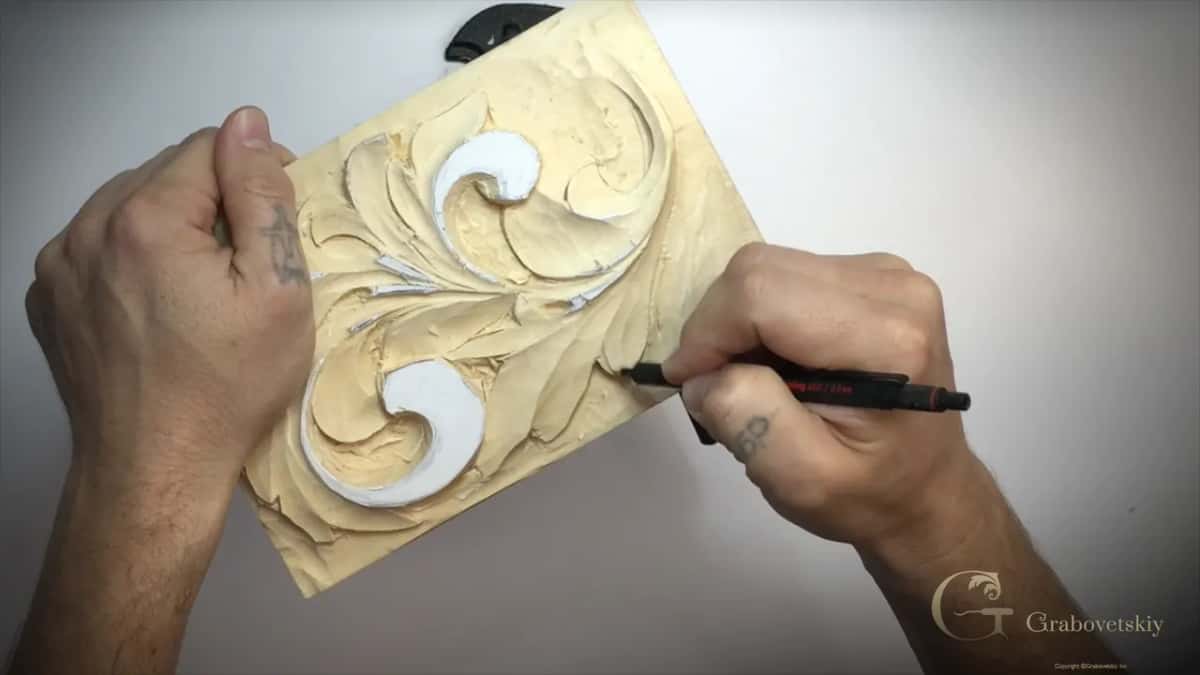 Black pencil on the carved panel, the left hand holding its left edge