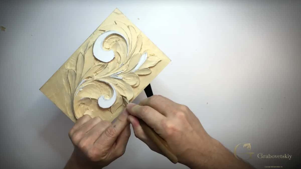 Panel on the diagonal, two hands at its lower corner