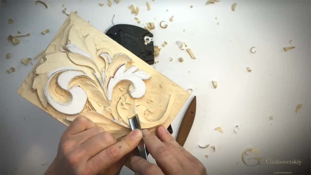 Two hands on a gouge at the lower right