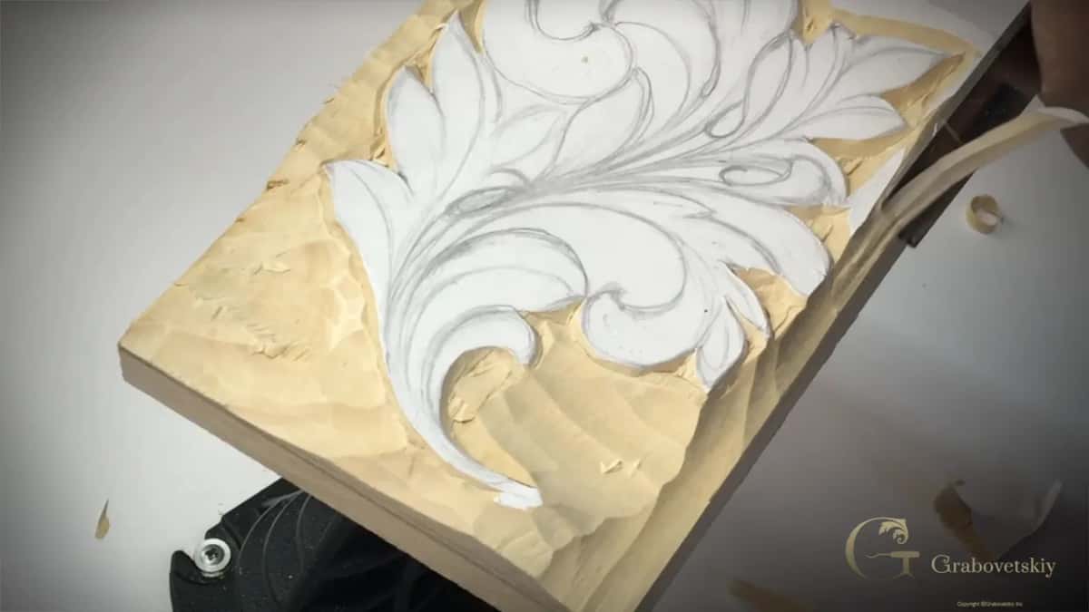 Long ribbon of wood peeling off under the gouge at the panel's right side
