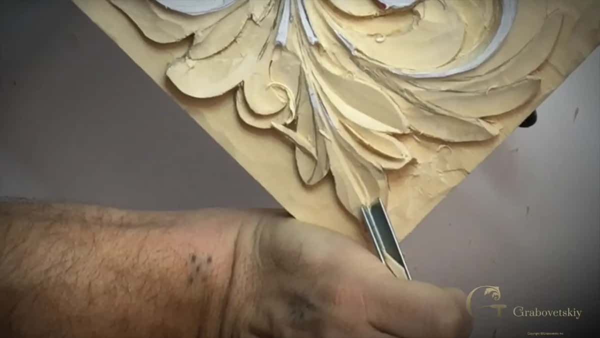 Forearm across the bottom of the panel, a V tool on the point of the lowest lobe
