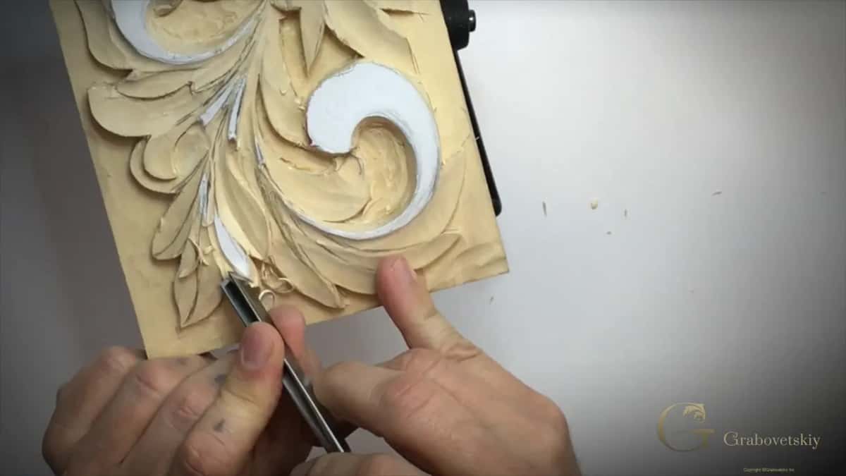Steel tool in both hands on a lower leaf