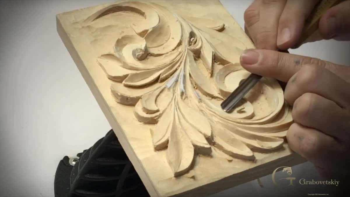 White paper still stuck along the middle stems while a gouge works one lobe