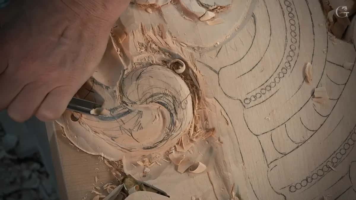 Gouge pushed into the swirl from the lower left, fresh grooves over the pencil lines