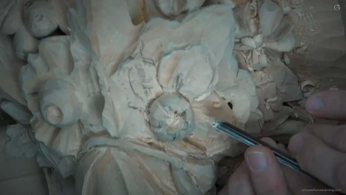 Seen from above, a straight tool works the petal right beside a small dark hole