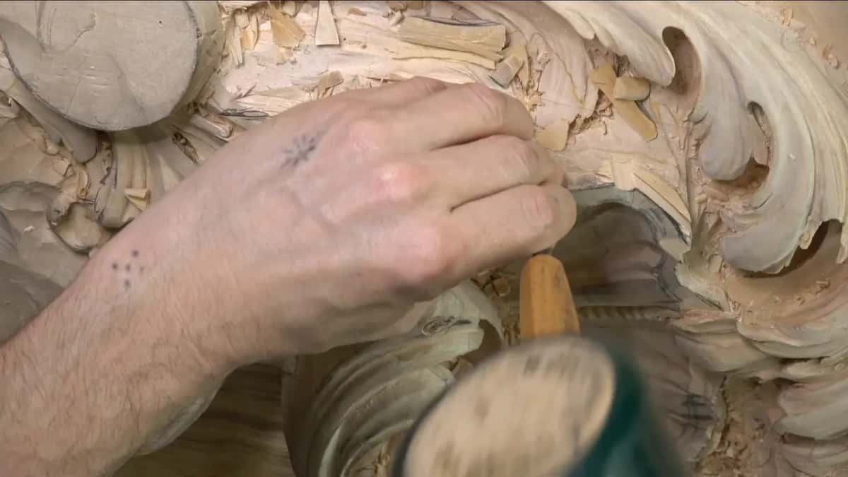 A round green mallet meets the end of a handle.