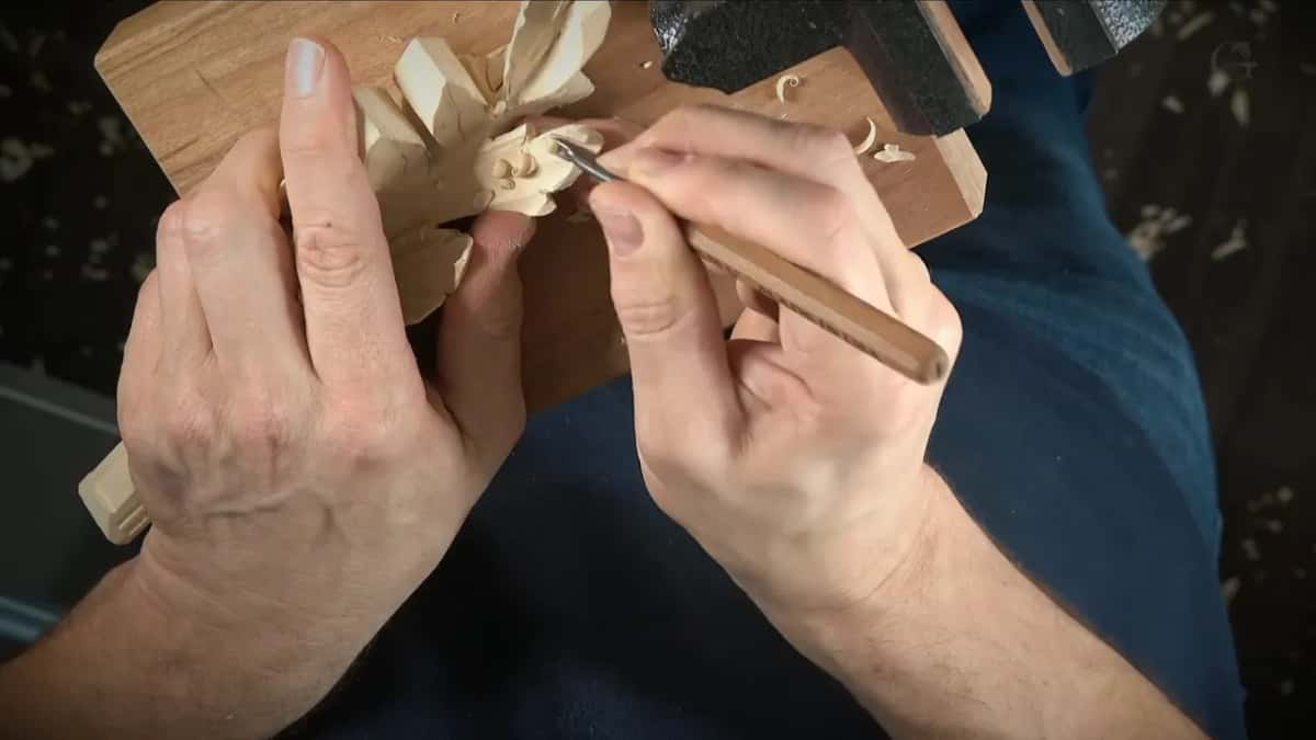 Small palm gouge working inside the curled tip of a basswood leaf