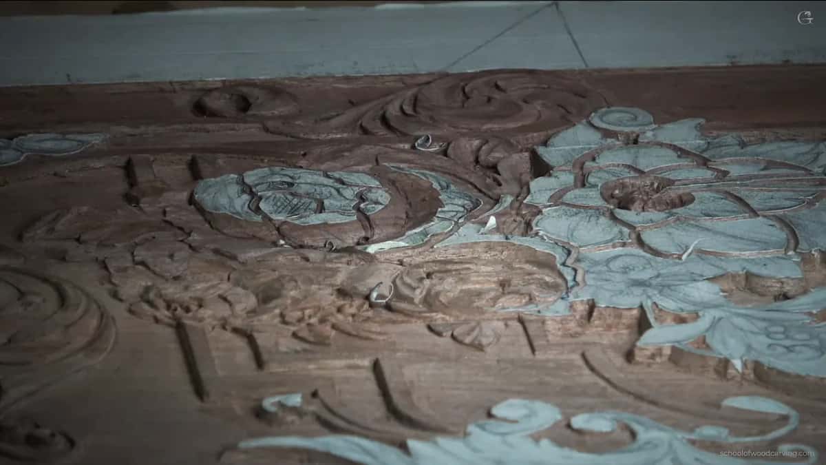 A low view along the whole panel, paper still over the flowers that are not carved yet
