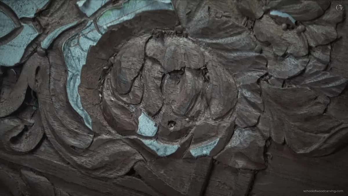 More petals carved now, dark gaps opening between them as the paper comes away