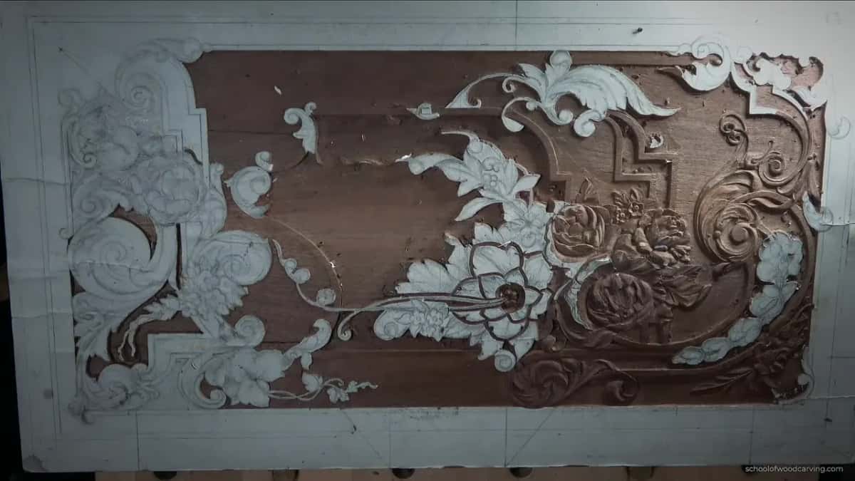 The whole walnut panel from above, paper still on the parts not carved yet, the left half mostly white