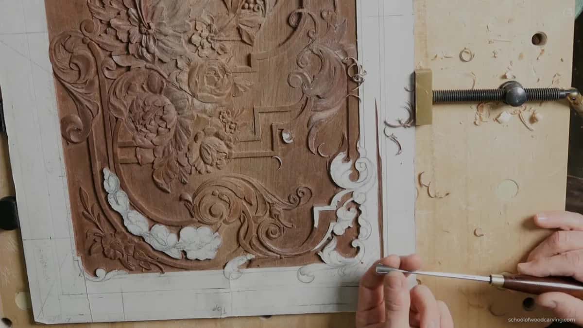 Overhead, a gouge with a dark handle held level at the lower right of the panel
