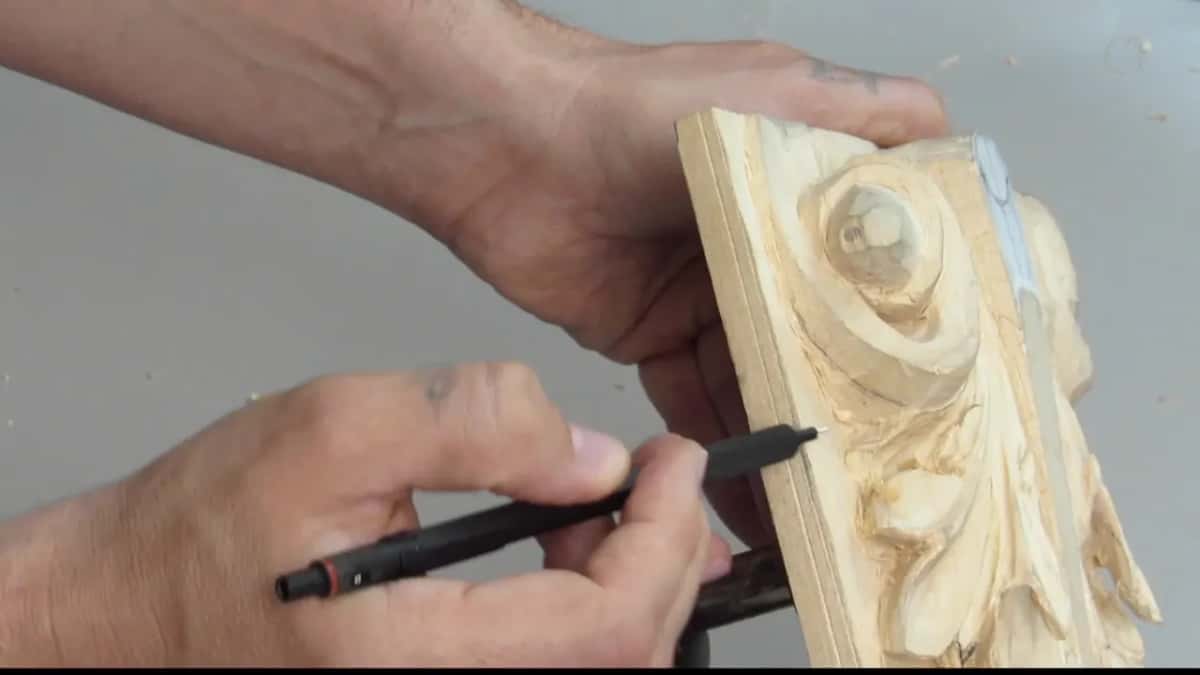 Panel almost edge on to the camera with a black pen held low in the other hand