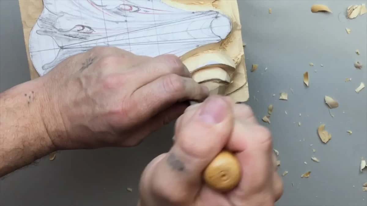 Closed fist on a pale handle inside the spiral