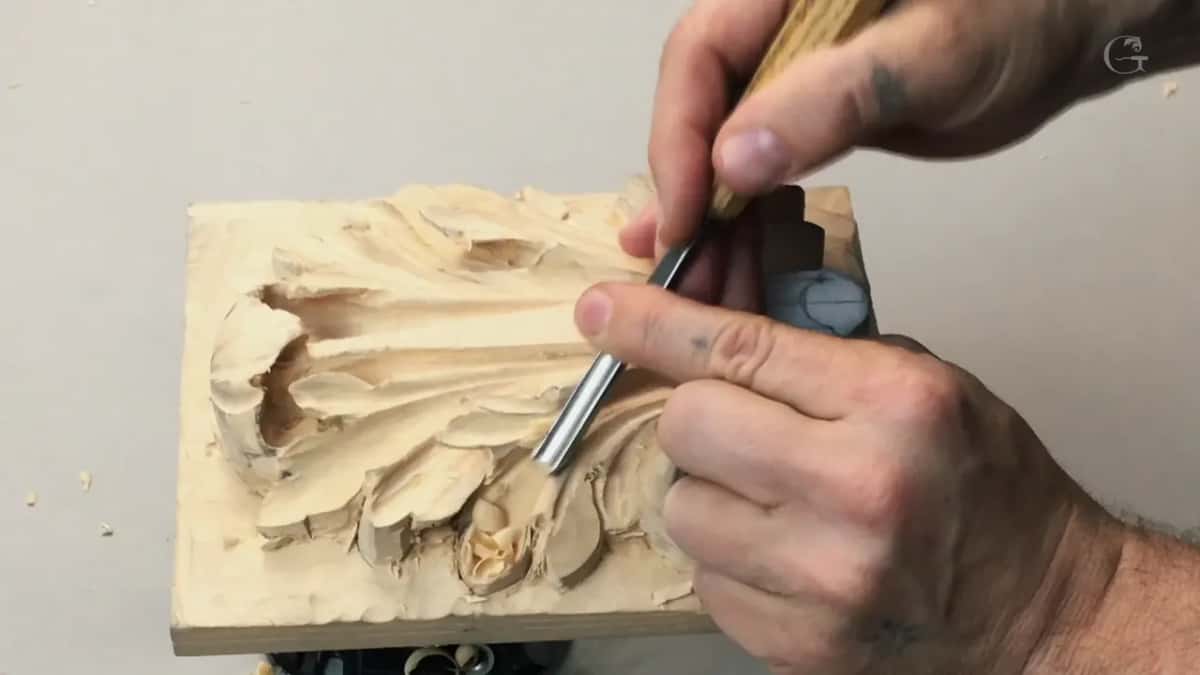 Pressed into the middle lobes, a steel blade under both hands, the panel tipped on the vise
