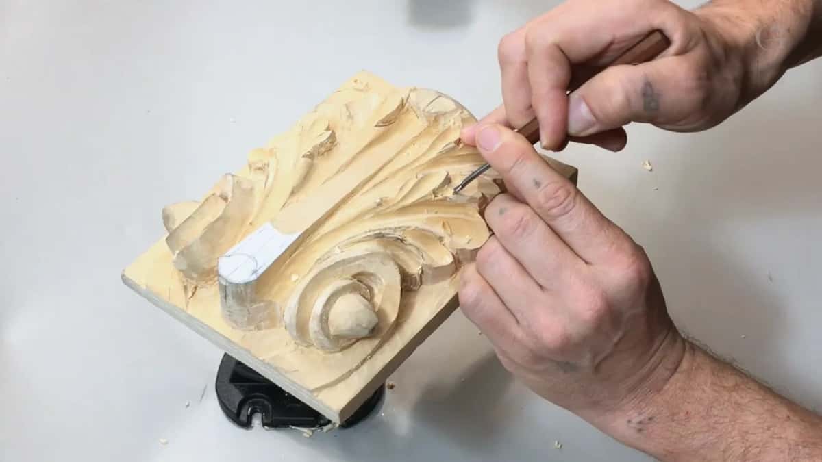 Fine blade pinched beside the scroll