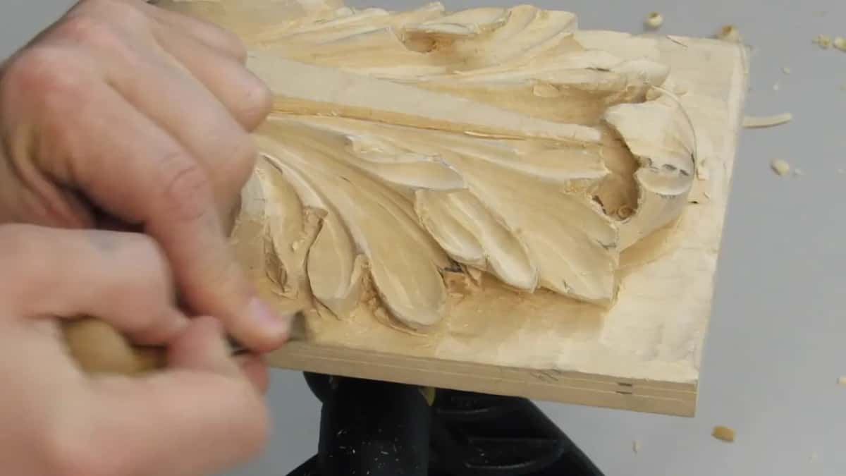 Beside the rotated board, two hands, one gripping a pale handle