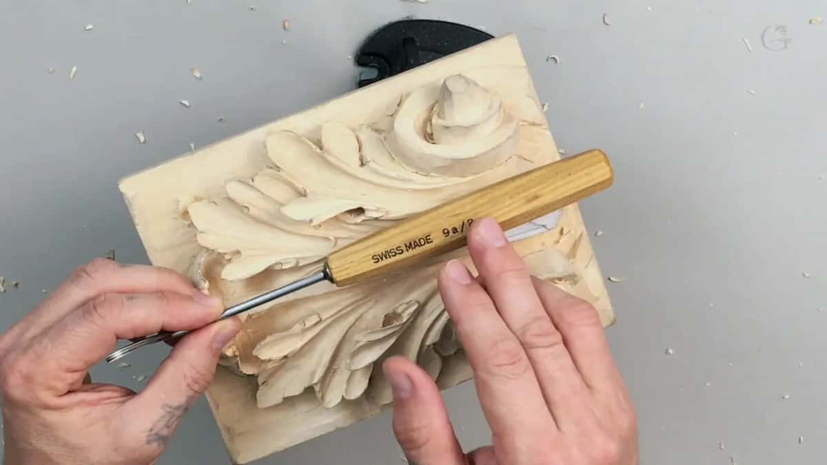 Pale handle stamped SWISS MADE 9a/2, held across the leaf