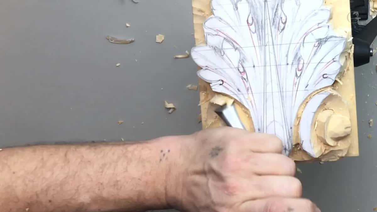 Forearm across the frame and a gouge near the tip, the right volute already rounded