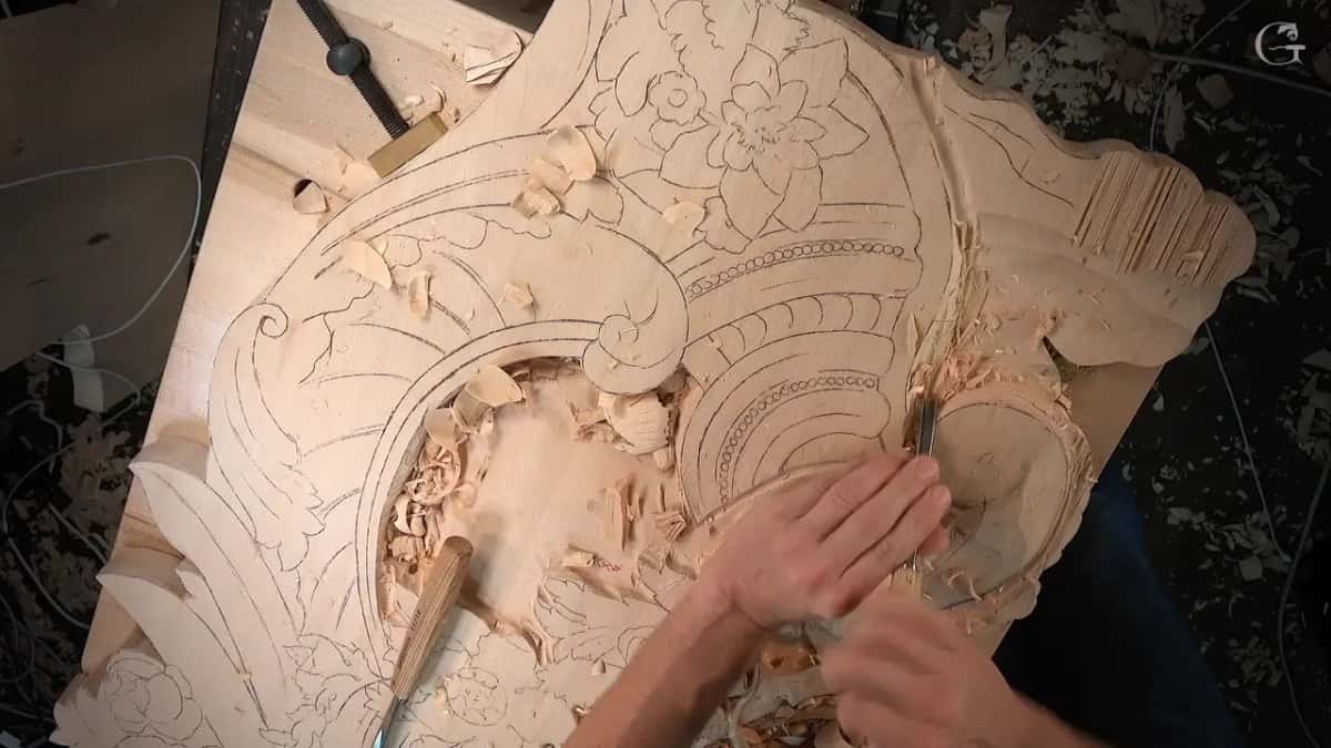 Both hands pushing a small gouge