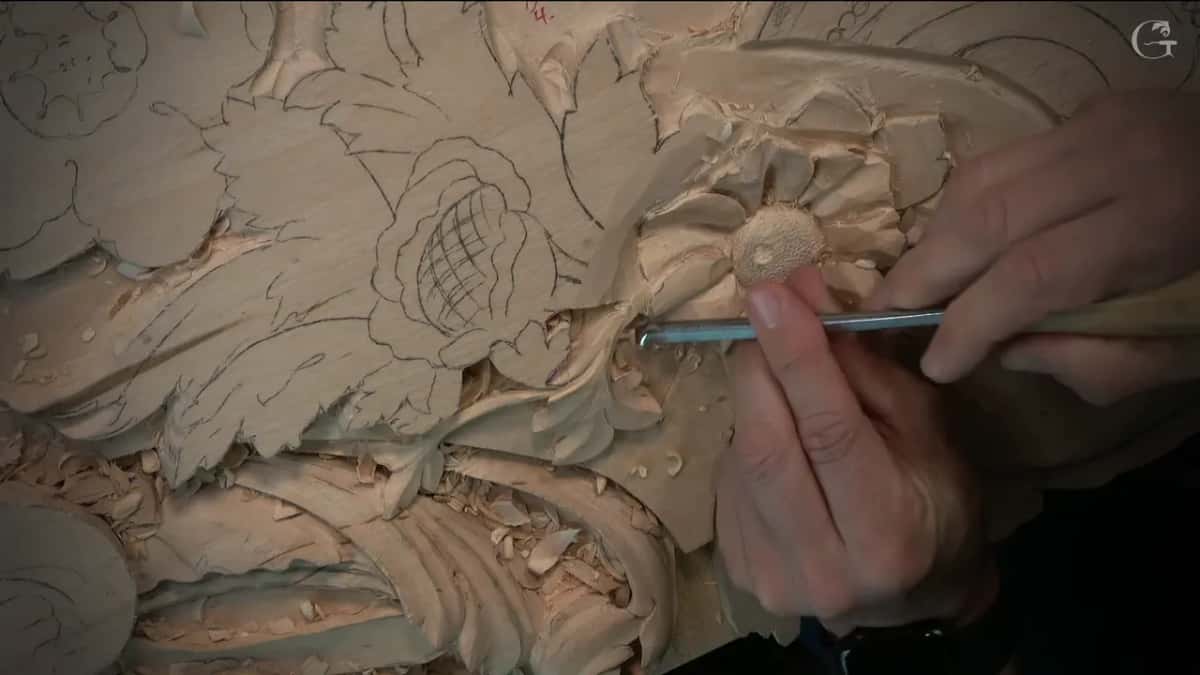 Thin gouge running along the rim of one petal, the punched middle of the flower just above it