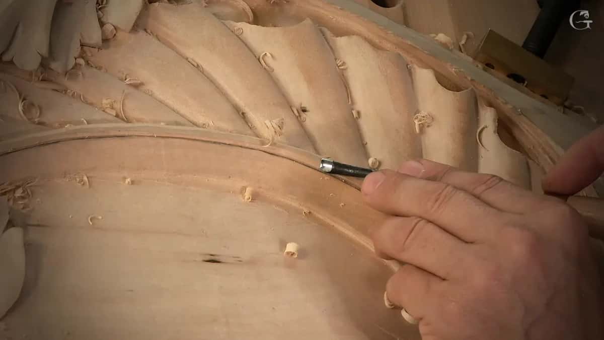 A small gouge pressed against the inside edge of the curved band