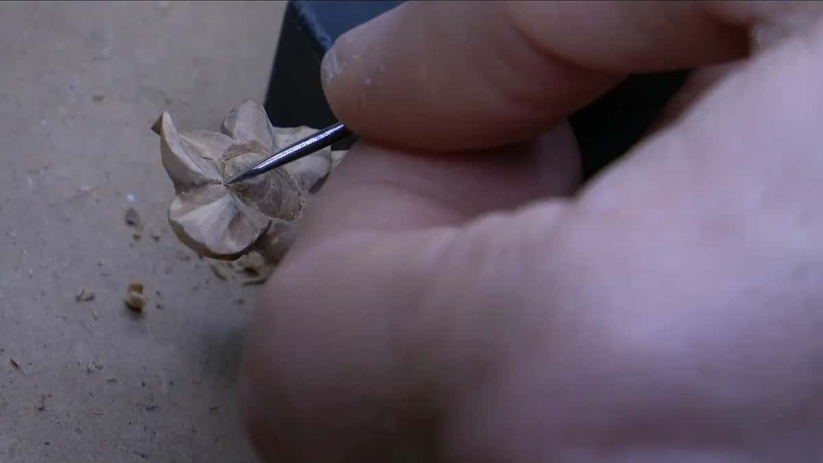 Pointed tool between two finished petals