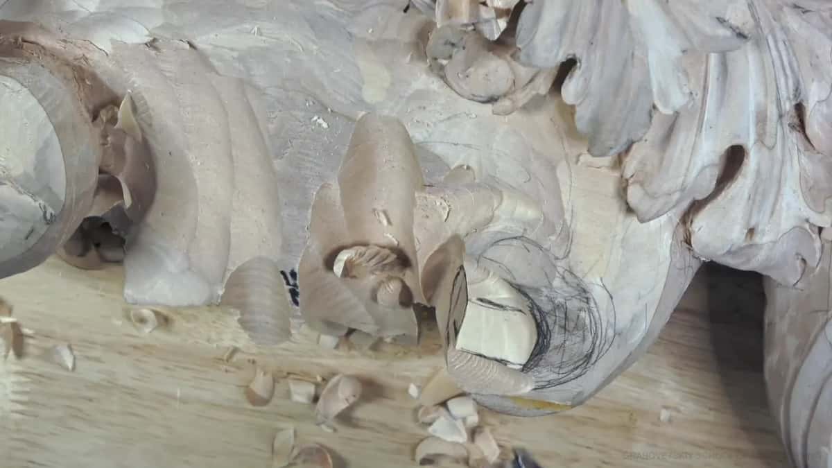 A pale square of fresh wood sits at the center of the pencil spiral.