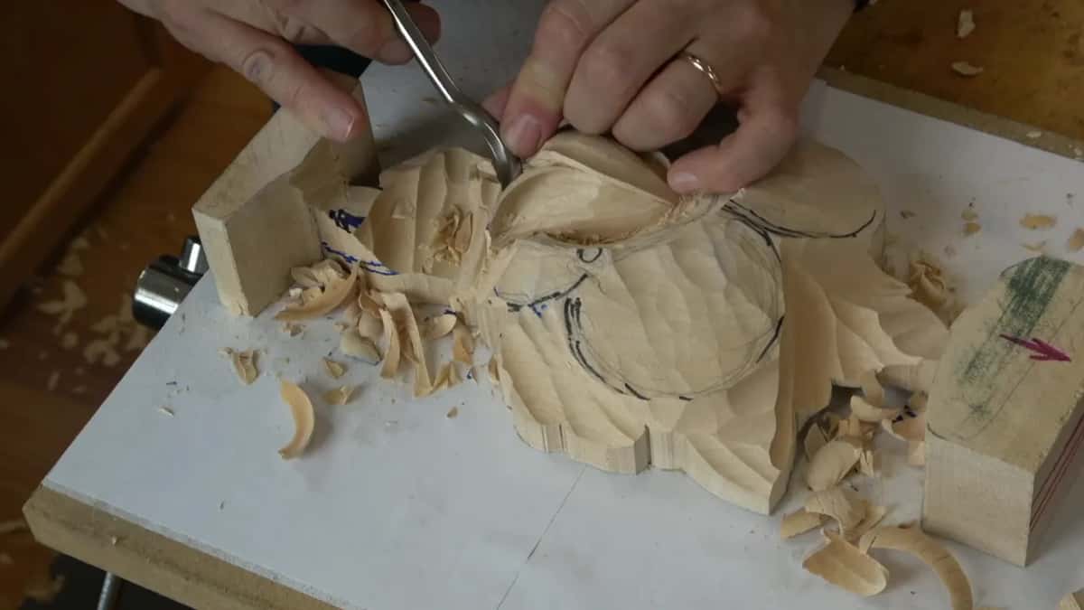 Both hands on a bent spoon at the left of the panel