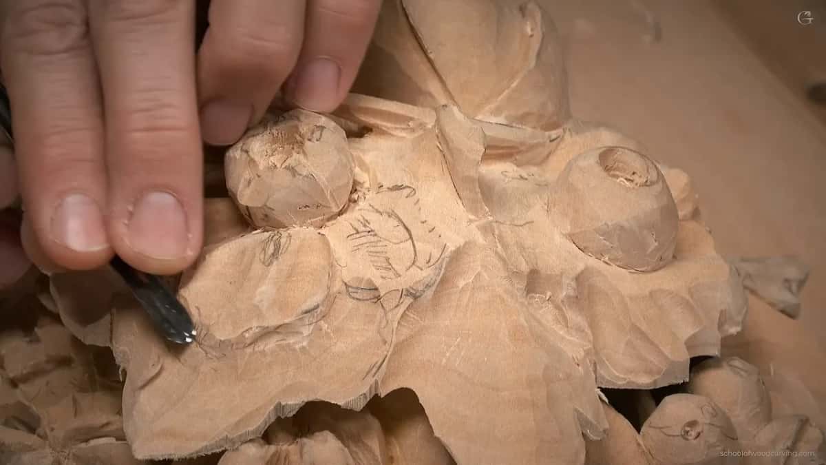 Fingers guide a small gouge