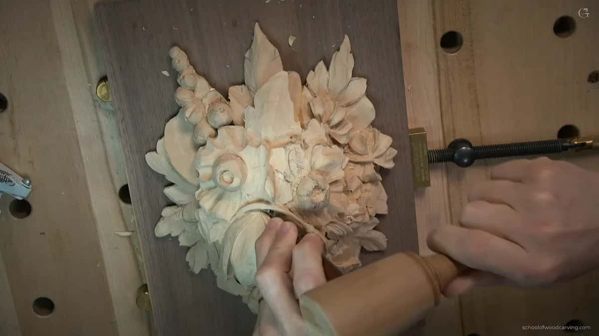 From above, fingertips on the curved stem and a pale turned handle in the other hand