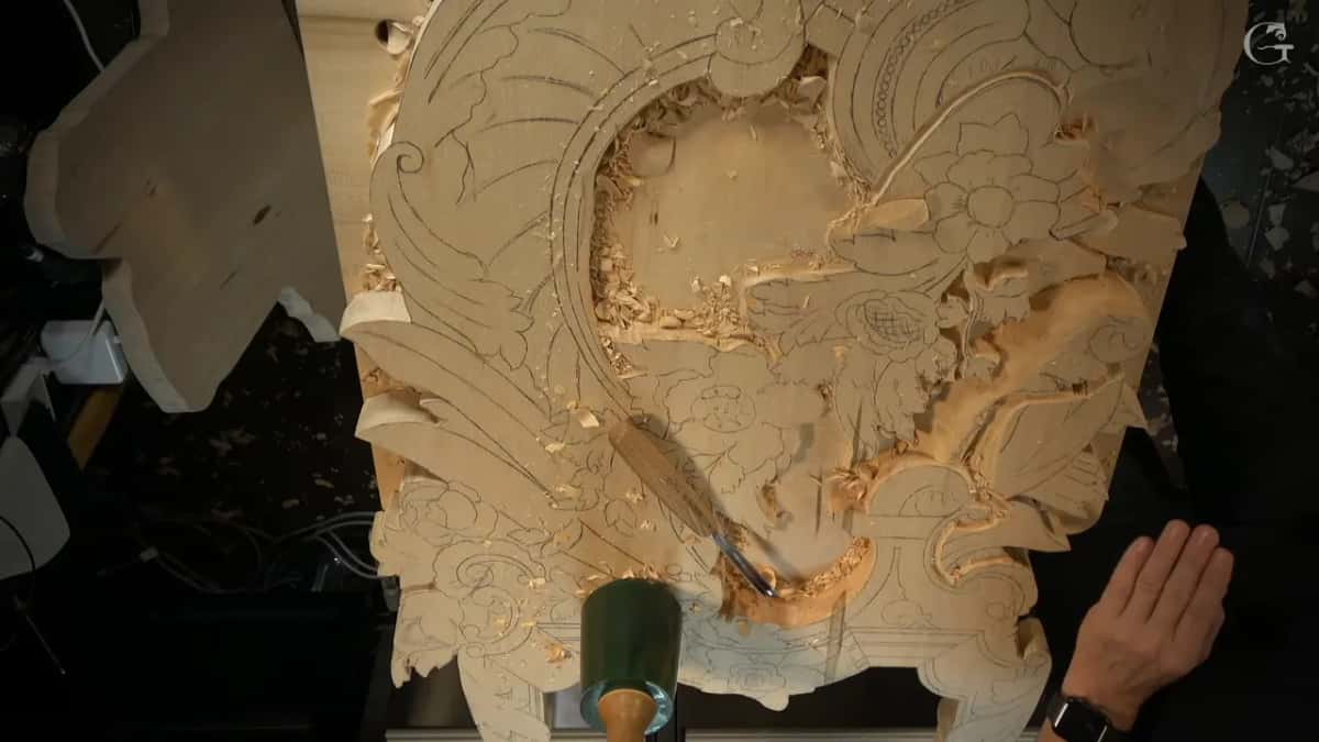 Green mallet and gouge resting on the rough panel
