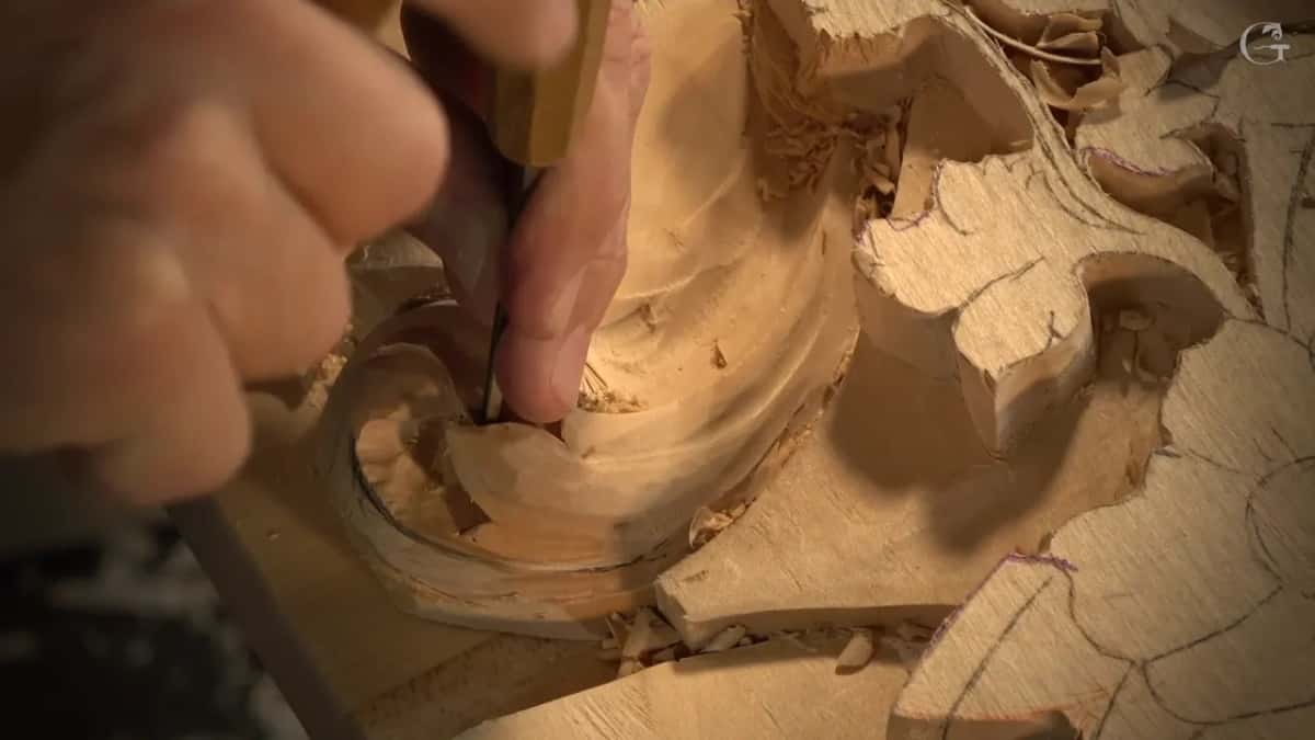 Inside the hollow, a gouge rests against the rolled edge.