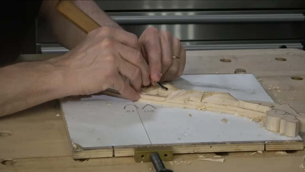 Both hands on a small tool.