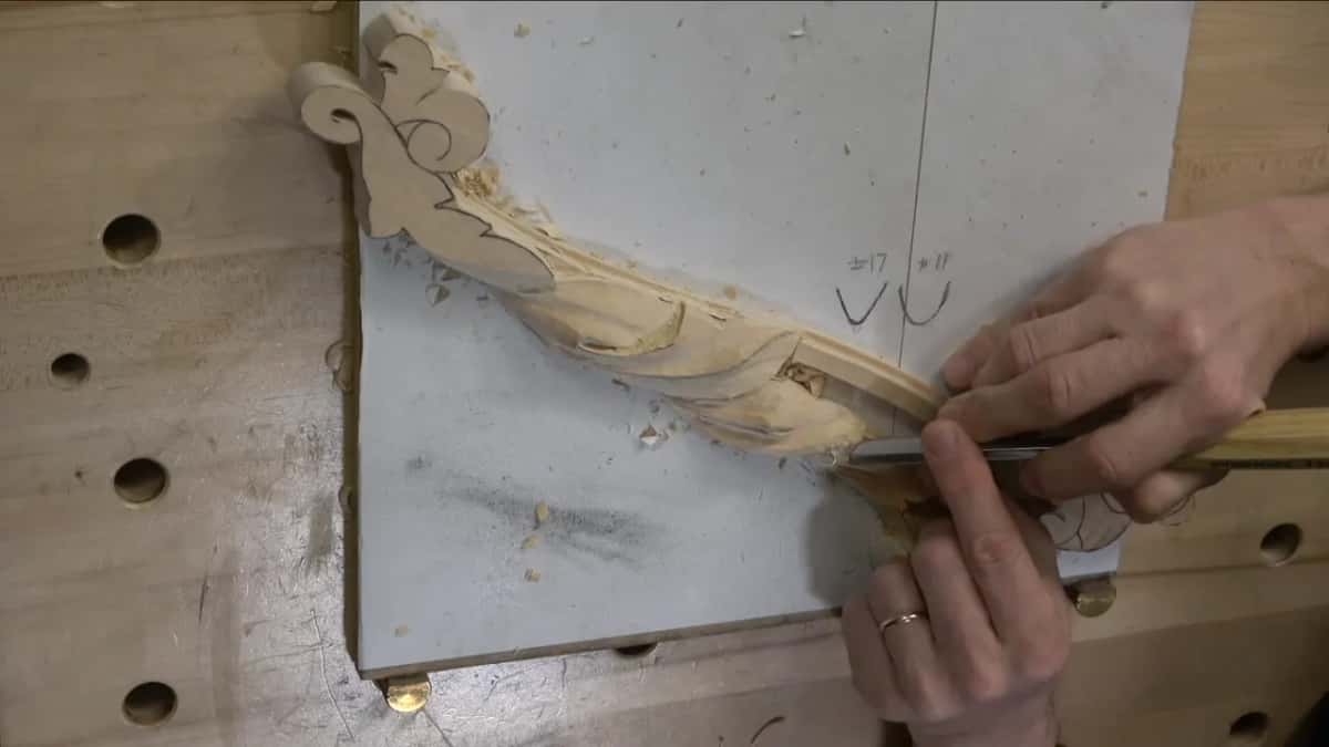 Two hands guide the tool into a hollow near the flower end.
