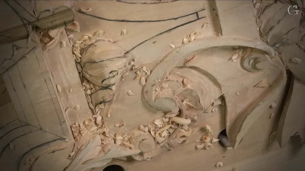 Shavings lie all around a carved volute