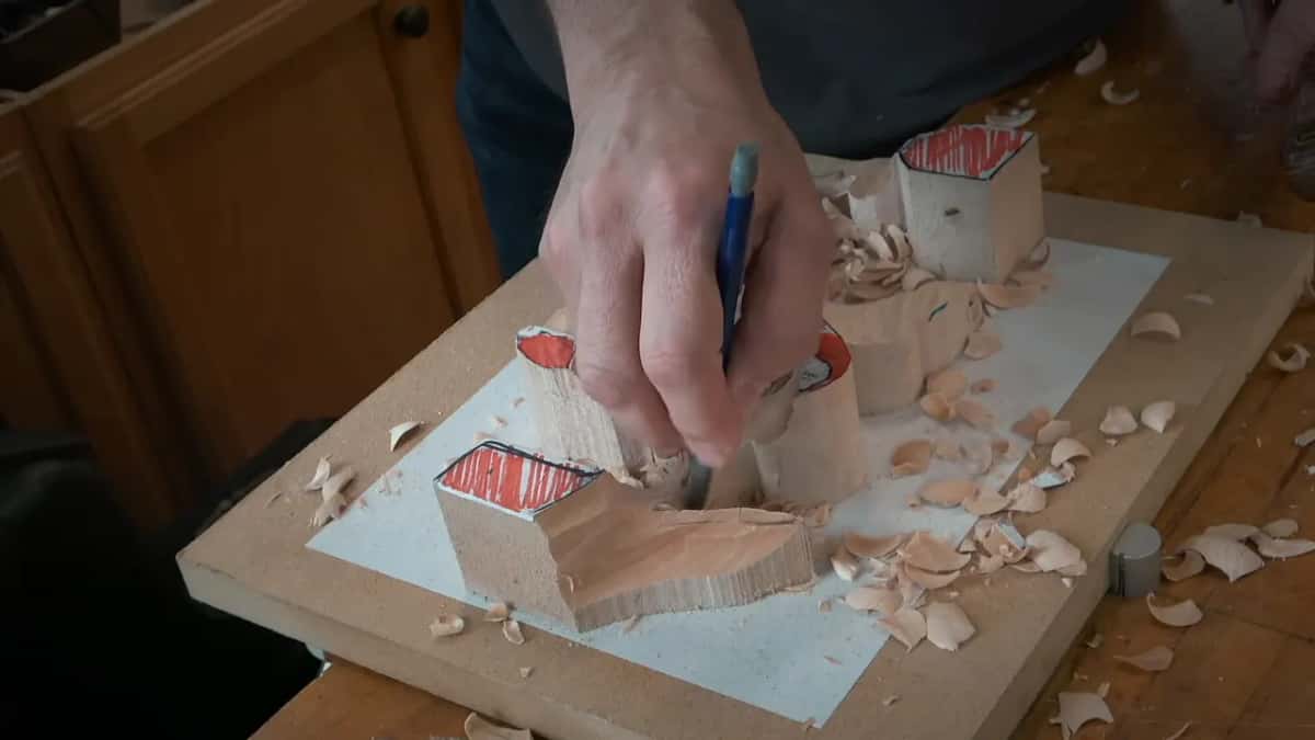 A short line marked low on the stem section, with chips piled on the white board around it