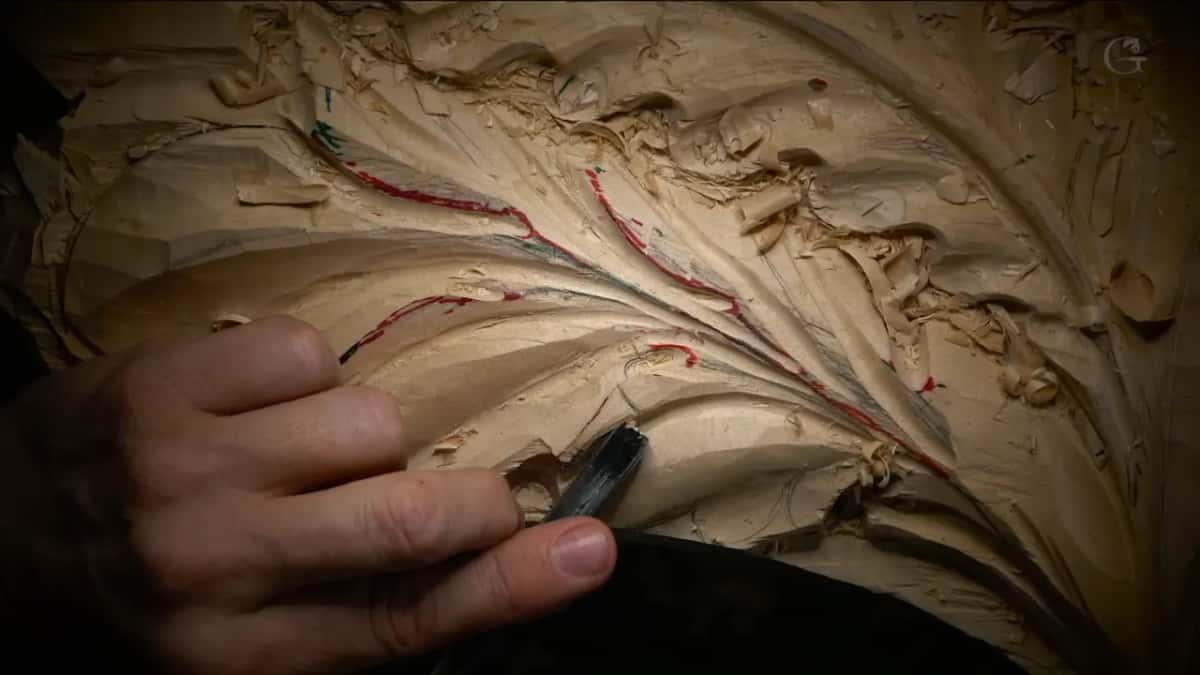 Colored lines Red and green pencil lines fanning along a leaf, one hand holding it, a dark tool below