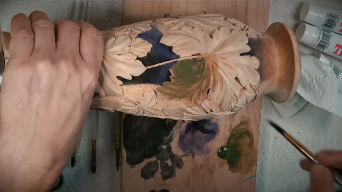 Green going onto one leaf, half of it still bare, with a blob of green paste on the board