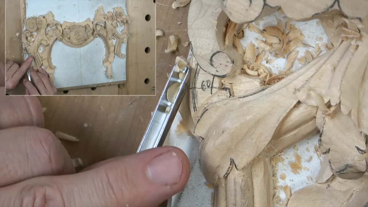 Thumb pressing a veiner turned on its side, pencil numbers written on the leaf