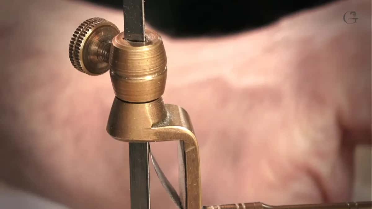 Knurled brass stop on the arm, close