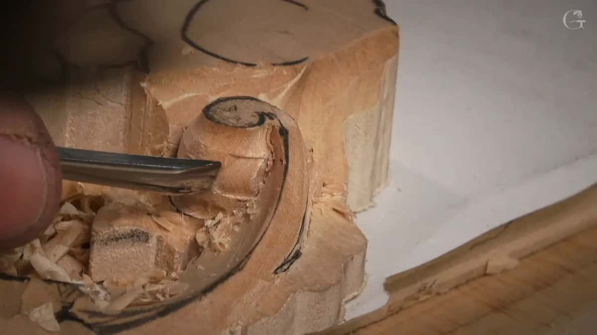 From the left, a narrow gouge works the rounded top while shavings fill the corner below
