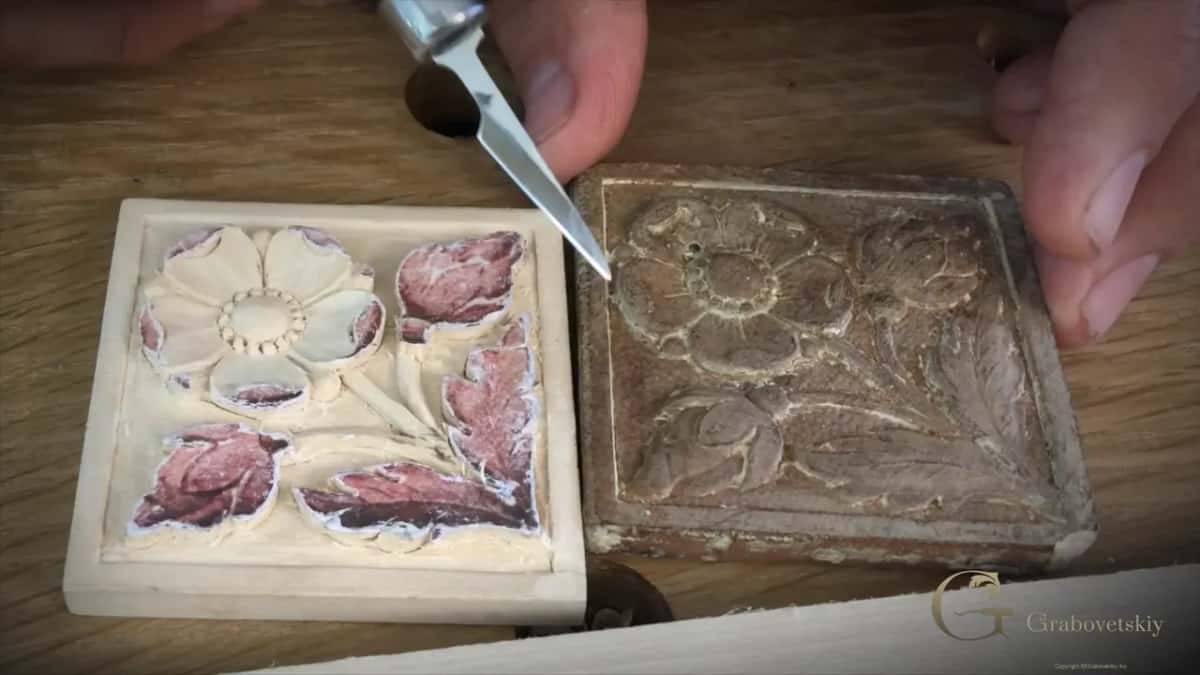 Knife tip at the original's edge, the copy on its left with a white flower center